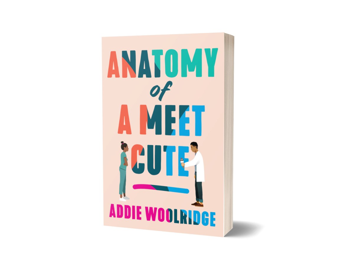 Cover of Anatomy of a meet cute. The background is a soft pink and the text is a tie-dye color with two people standing on the front. The woman is in green scrubs and has her arms crossed. The man is in a white coat and is holding an ice cream cone.